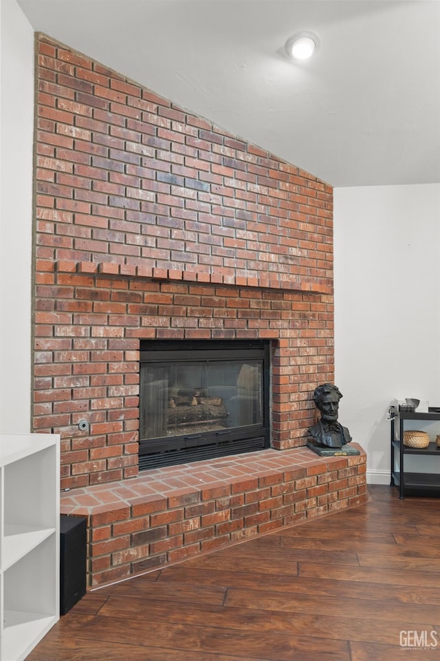 details with wood-type flooring and a brick fireplace