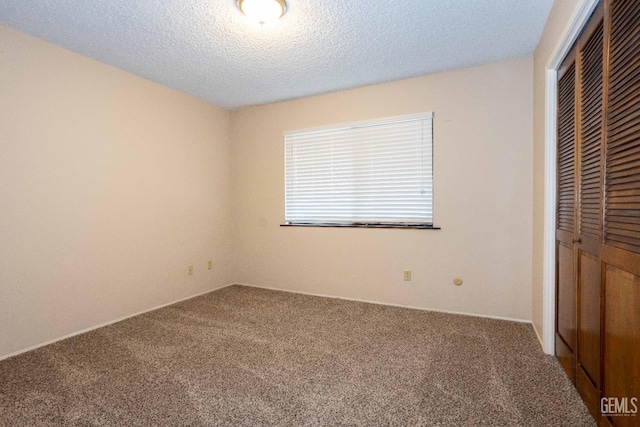 unfurnished bedroom with a closet, a textured ceiling, and carpet flooring