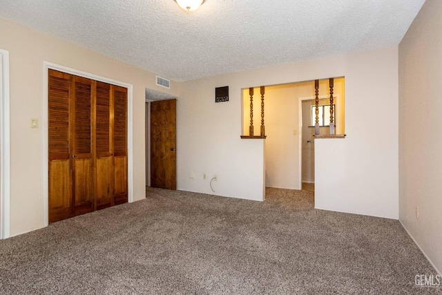 unfurnished bedroom with a closet, a textured ceiling, and carpet