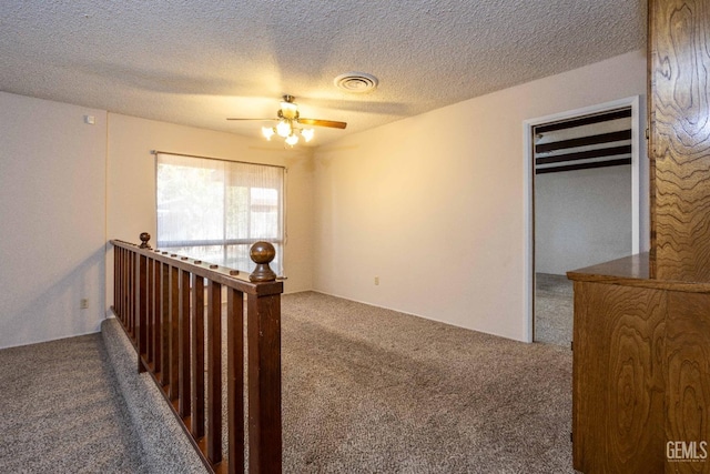 interior space featuring a textured ceiling and carpet