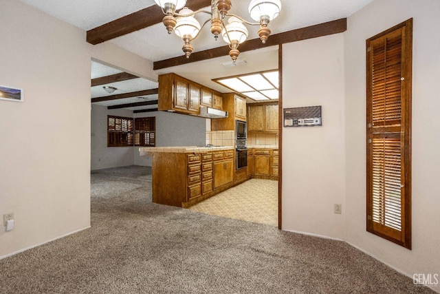 kitchen with black appliances, light carpet, beam ceiling, and kitchen peninsula