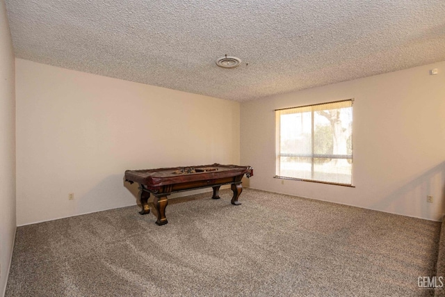 game room with carpet floors and a textured ceiling