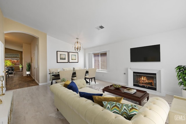 living room featuring light hardwood / wood-style flooring and a notable chandelier