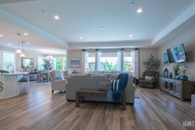 13620 Stonethwaite Ln, Bakersfield, CA 93311 - living area with wood finished floors, a chandelier, a raised ceiling, and recessed lighting