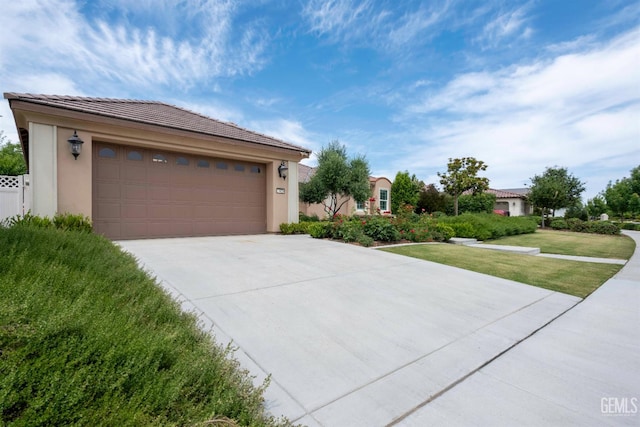 13620 Stonethwaite Ln, Bakersfield, CA 93311 - view of front of property featuring a tile roof, stucco siding, driveway, and a front yard
