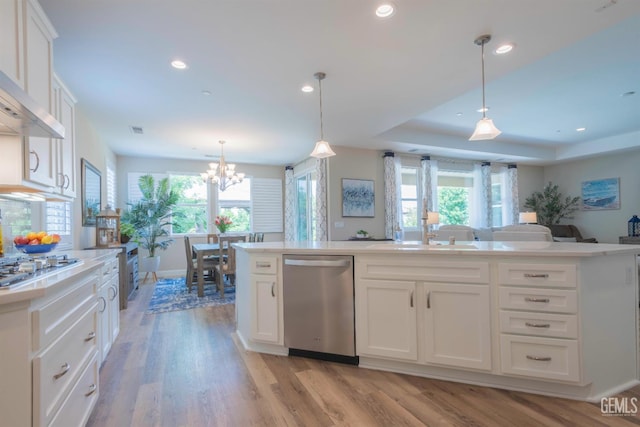 13620 Stonethwaite Ln, Bakersfield, CA 93311 - kitchen with stainless steel appliances, open floor plan, plenty of natural light, wall chimney range hood, and recessed lighting