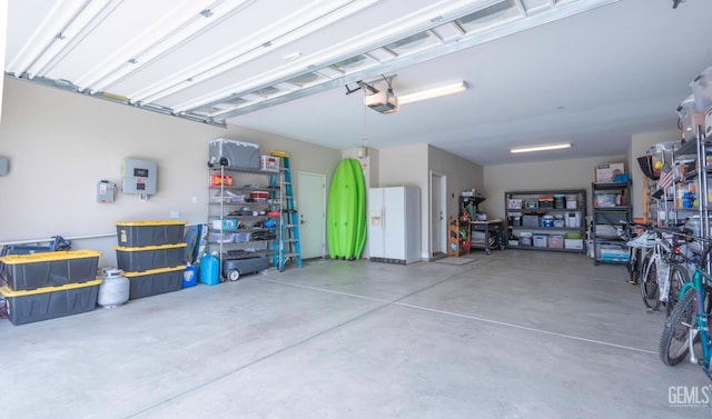 13620 Stonethwaite Ln, Bakersfield, CA 93311 - garage featuring a garage door opener and white refrigerator with ice dispenser