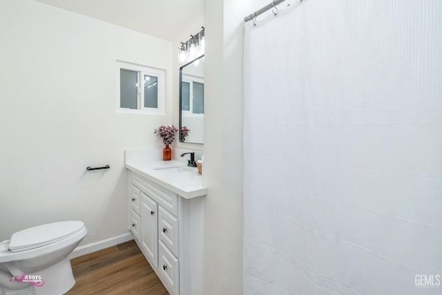 bathroom featuring vanity, hardwood / wood-style flooring, and toilet