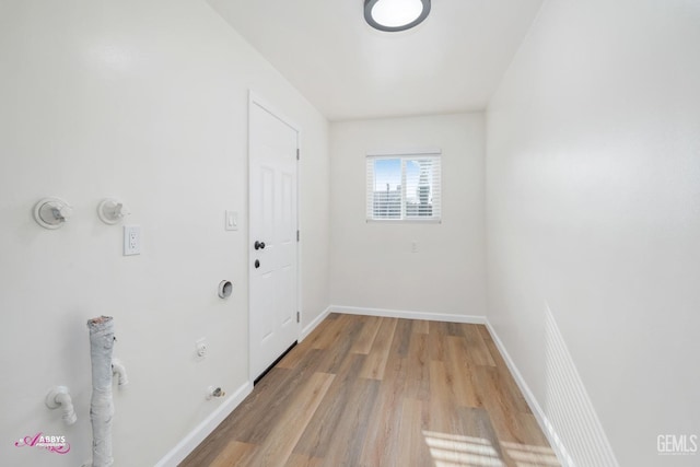 washroom with light wood-type flooring and hookup for a gas dryer