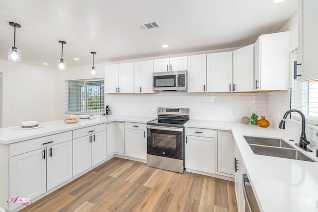 kitchen featuring sink, white cabinets, and stainless steel appliances