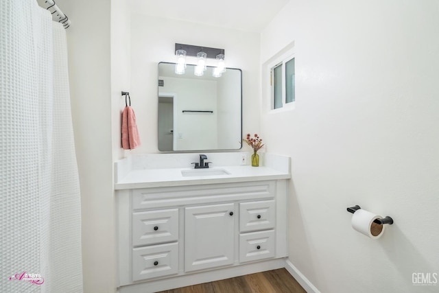 bathroom featuring hardwood / wood-style flooring, vanity, and a shower with curtain