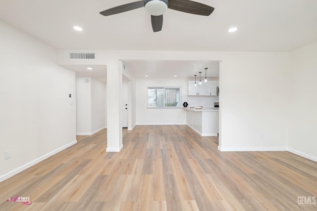 unfurnished living room with ceiling fan and light hardwood / wood-style floors