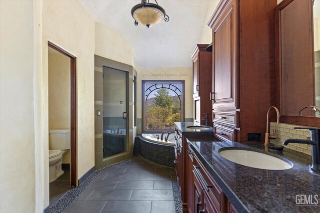 28221 Cumberland Rd, Tehachapi, CA 93561 - bathroom featuring lofted ceiling, toilet, a bath, vanity, and baseboards