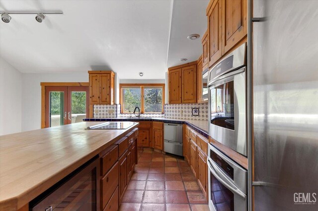 28221 Cumberland Rd, Tehachapi, CA 93561 - kitchen featuring stainless steel appliances, a sink, wine cooler, tasteful backsplash, and wood counters