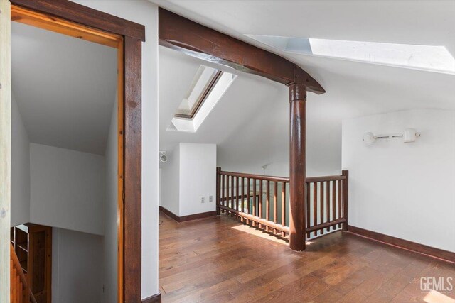 28221 Cumberland Rd, Tehachapi, CA 93561 - additional living space with a skylight, wood finished floors, vaulted ceiling, and baseboards