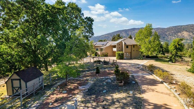28221 Cumberland Rd, Tehachapi, CA 93561 - view of front of house with a mountain view, stucco siding, and solar panels