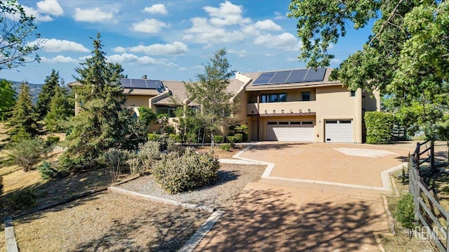 28221 Cumberland Rd, Tehachapi, CA 93561 - view of front of home with stucco siding, a garage, driveway, and solar panels
