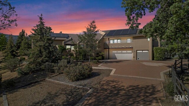 28221 Cumberland Rd, Tehachapi, CA 93561 - multi unit property featuring stucco siding, driveway, a garage, and solar panels