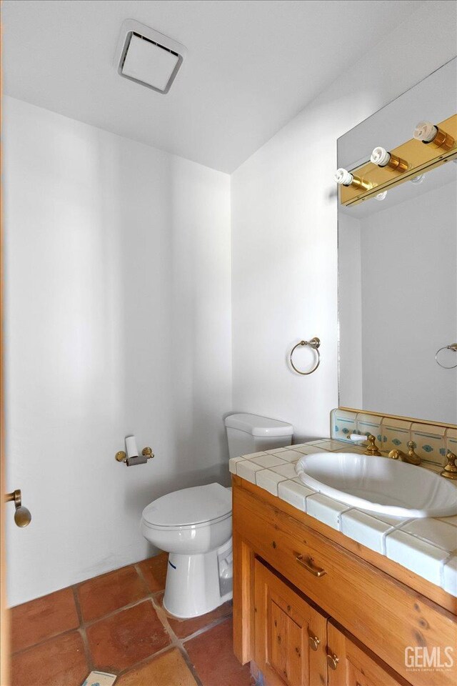 28221 Cumberland Rd, Tehachapi, CA 93561 - bathroom featuring toilet, vanity, and tile patterned flooring