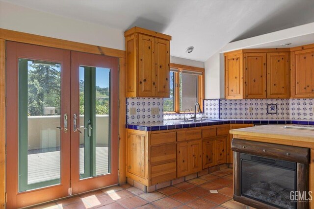28221 Cumberland Rd, Tehachapi, CA 93561 - kitchen with tasteful backsplash, tile countertops, french doors, a sink, and lofted ceiling