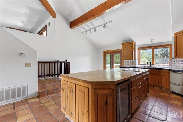 28221 Cumberland Rd, Tehachapi, CA 93561 - kitchen featuring beverage cooler, wooden counters, backsplash, dishwashing machine, and track lighting