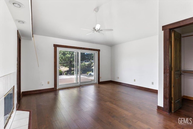 28221 Cumberland Rd, Tehachapi, CA 93561 - unfurnished living room featuring ceiling fan, wood finished floors, baseboards, and a tiled fireplace