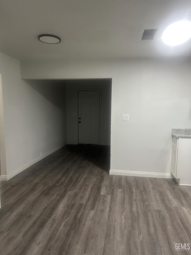 1225 Austin St, Delano, CA 93215 - unfurnished room with dark wood-type flooring and baseboards