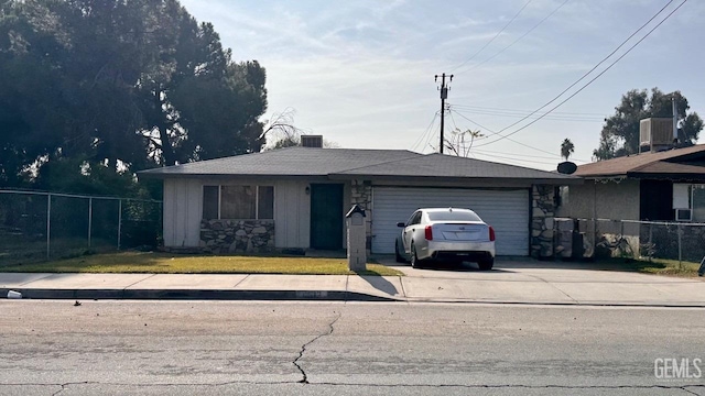 single story home with a garage and central AC