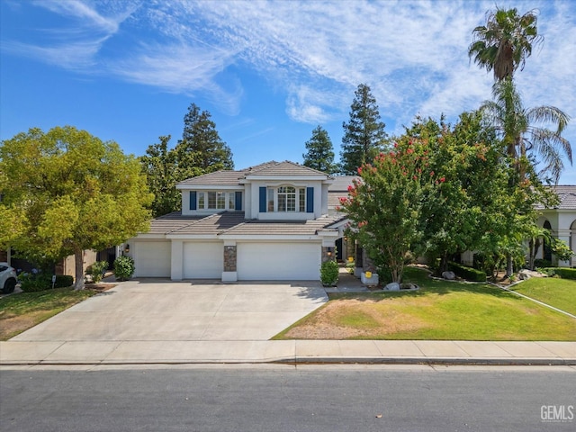 view of front facade with a front yard and a garage