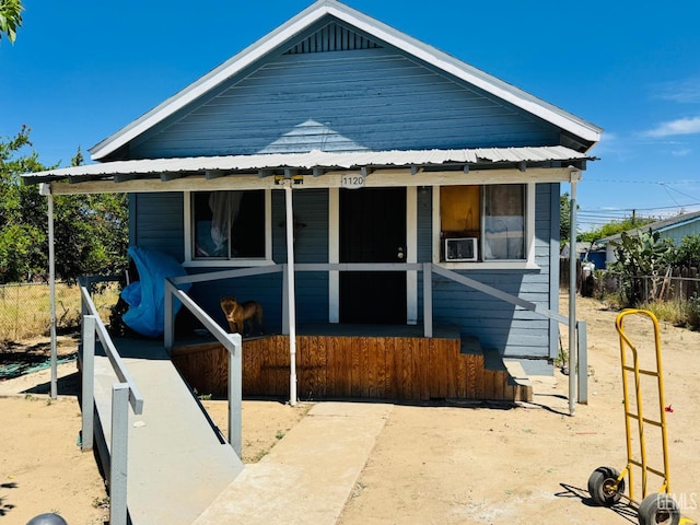 1120 Fremont St, Delano, CA 93215 - view of front of house featuring a porch, metal roof, and fence