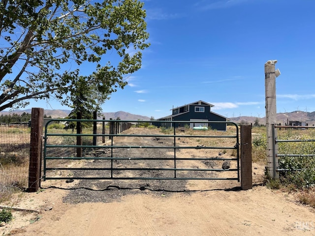 view of gate with a mountain view