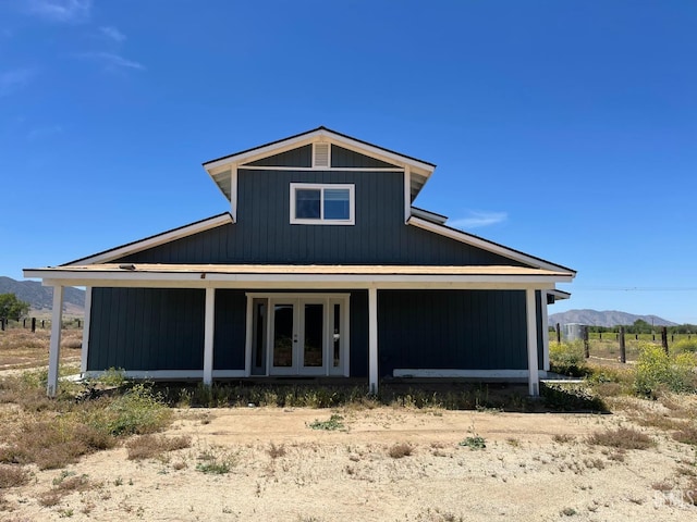 rear view of property featuring a mountain view and french doors