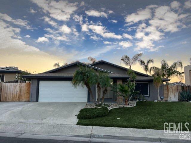 ranch-style home with a garage and driveway