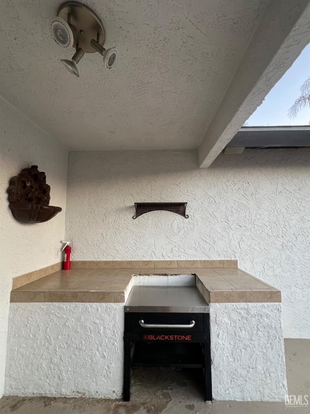 detailed view of stucco siding and a fire extinguisher