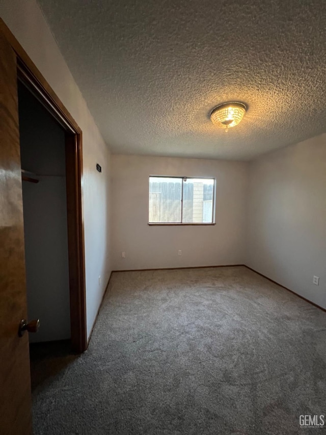 unfurnished bedroom with carpet floors and a textured ceiling