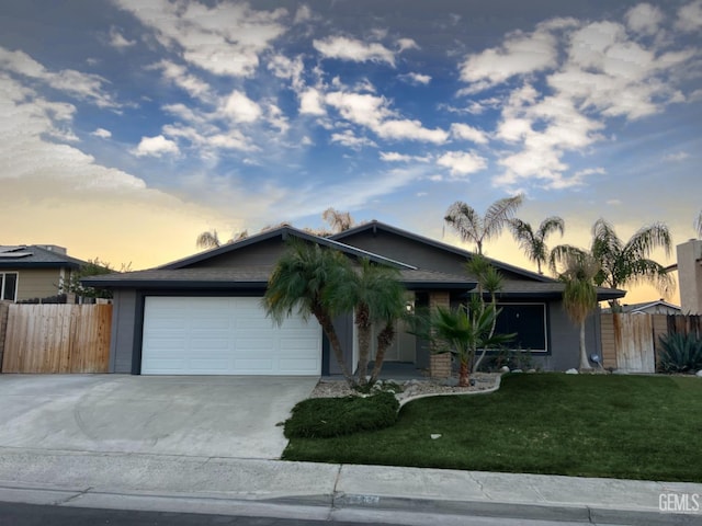 ranch-style home with an attached garage and concrete driveway