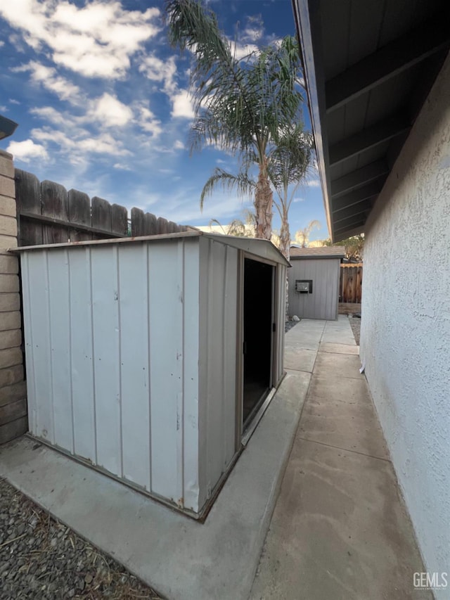 view of shed featuring fence