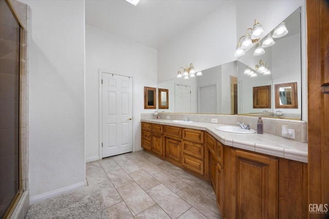 bathroom featuring vanity, a shower with door, and a chandelier