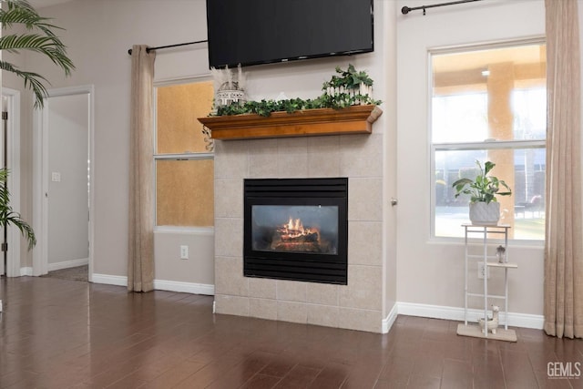 unfurnished living room with a fireplace and dark hardwood / wood-style flooring