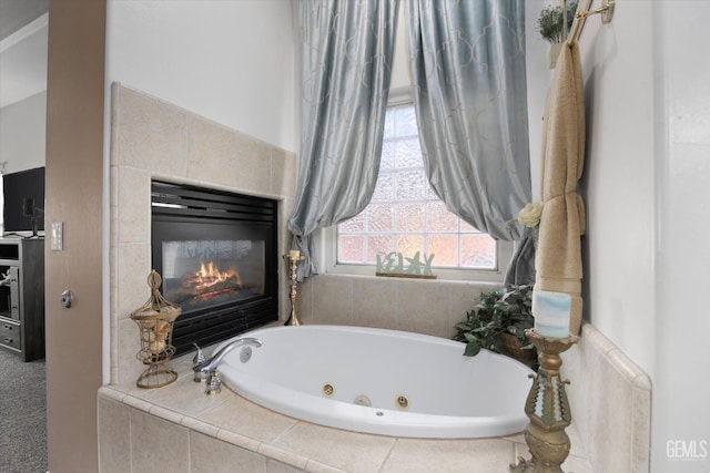 bathroom with a relaxing tiled tub and a fireplace