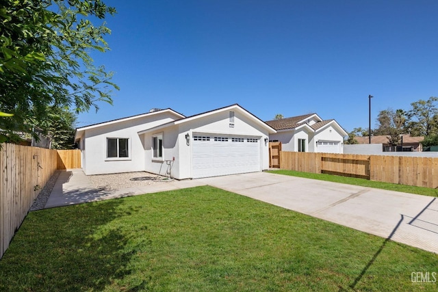 ranch-style house featuring a front yard and a garage