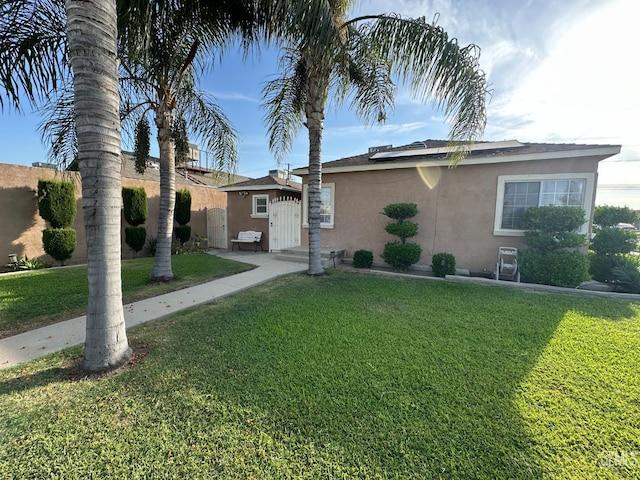 1022 9th Ave, Delano, CA 93215 - ranch-style house with stucco siding and roof mounted solar panels