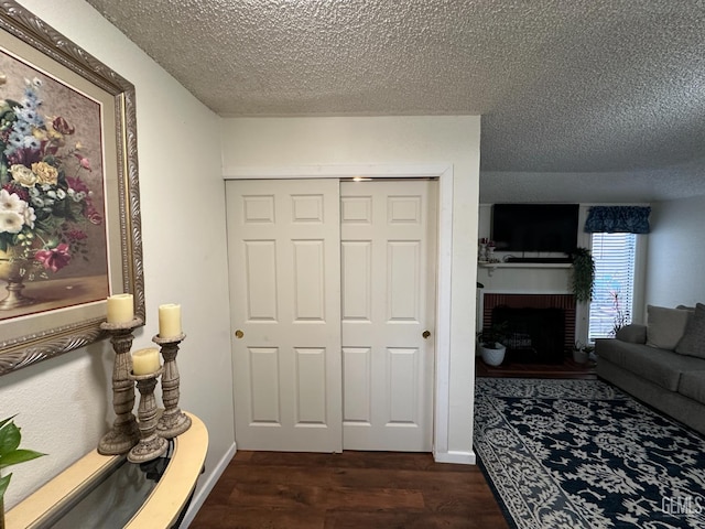 1022 9th Ave, Delano, CA 93215 - corridor featuring a textured ceiling and dark wood-type flooring