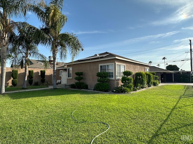 1022 9th Ave, Delano, CA 93215 - view of front of home with stucco siding, a front lawn, driveway, and a carport