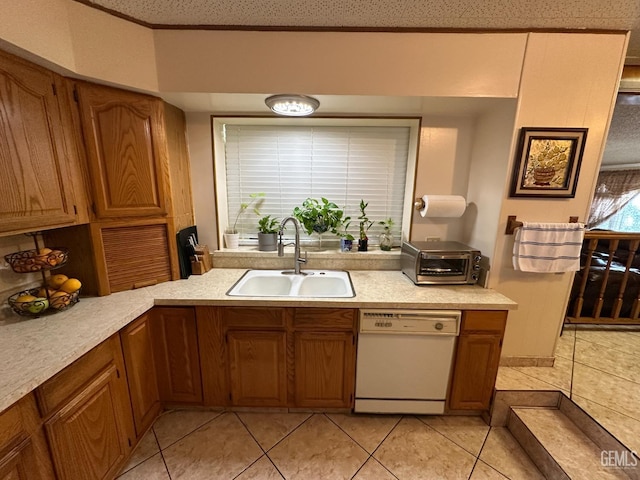 1022 9th Ave, Delano, CA 93215 - kitchen with white dishwasher, brown cabinets, and light countertops