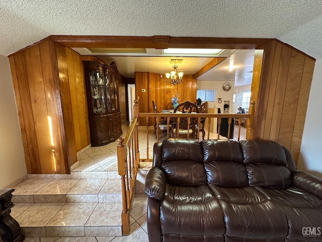 1022 9th Ave, Delano, CA 93215 - living room with a chandelier, a textured ceiling, and wooden walls