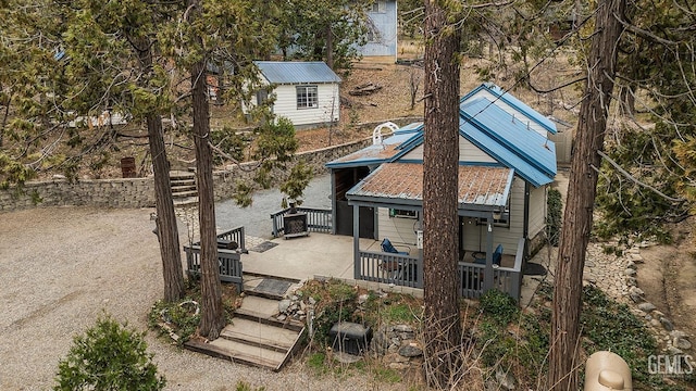 rear view of property featuring metal roof