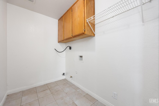 132 E Center St, Taft, CA 93268 - laundry area featuring cabinet space, washer hookup, hookup for a gas dryer, electric dryer hookup, and light tile patterned floors