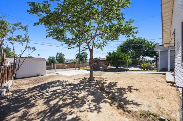132 E Center St, Taft, CA 93268 - fenced backyard with a patio and a storage unit