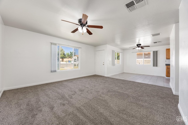 132 E Center St, Taft, CA 93268 - unfurnished living room with a ceiling fan, light carpet, healthy amount of natural light, and light tile patterned floors